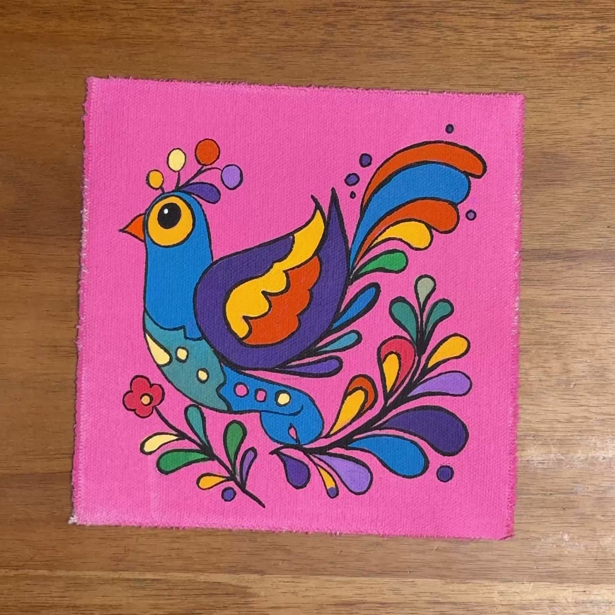 The folk bird painting on the studio table