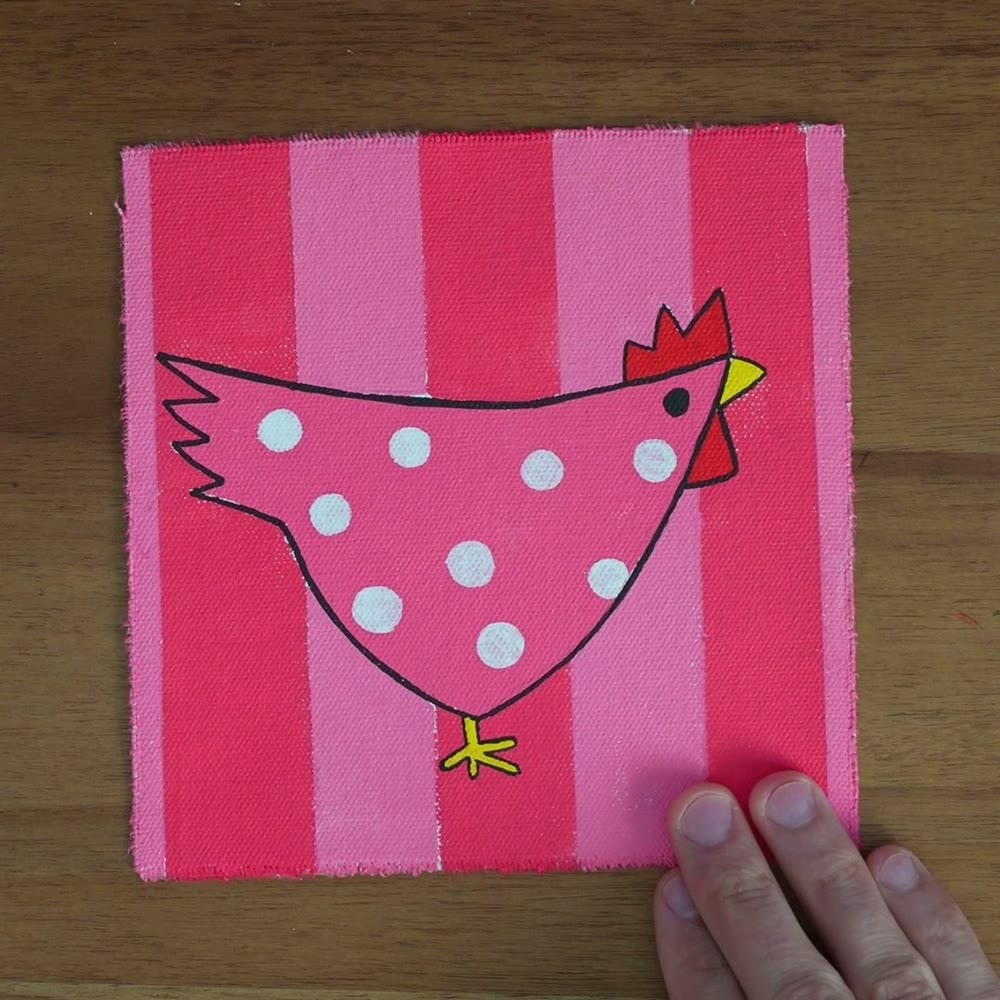 The pink chicken painting on the studio table