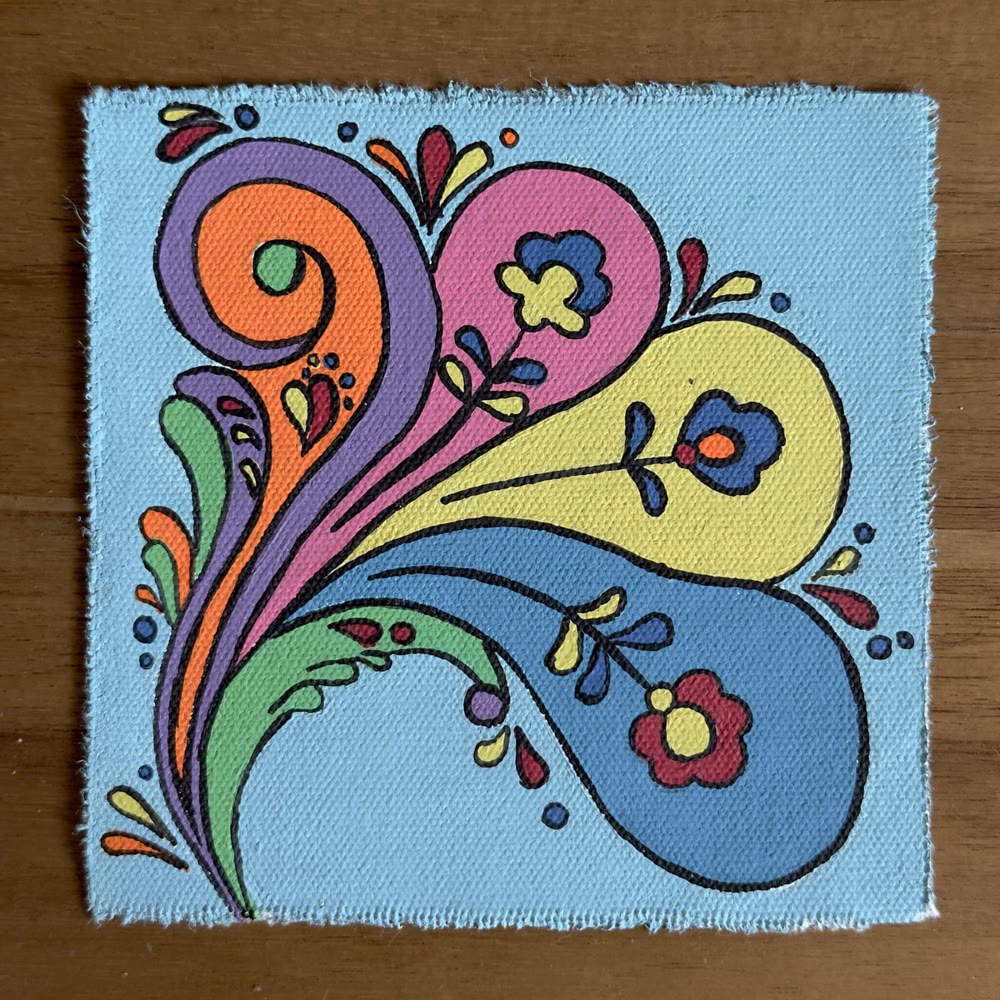 The floral swirl painting on the studio table